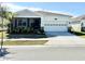 Charming single-story home featuring a two-car garage, screened entry, and well-maintained landscaping at 34004 Sky Blossom Cir, Leesburg, FL 34788