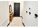 Entryway featuring stone-look flooring, a black door, and decorative Mickey Mouse wall hooks at 34004 Sky Blossom Cir, Leesburg, FL 34788