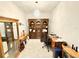 Organized home office space with ample storage, two desks, overhead light fixture, and tile flooring at 34004 Sky Blossom Cir, Leesburg, FL 34788