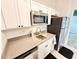 This bright kitchen features white cabinets, stainless steel appliances, and a stylish countertop at 34004 Sky Blossom Cir, Leesburg, FL 34788