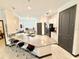 Modern kitchen with a large center island and seating, stainless appliances, and open layout to living spaces at 34004 Sky Blossom Cir, Leesburg, FL 34788