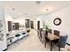 Bright, modern kitchen with stainless steel appliances, large island with seating, and stylish pendant lighting at 34004 Sky Blossom Cir, Leesburg, FL 34788