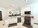 Modern kitchen featuring stainless steel appliances, a large island with sink, and open layout to living spaces at 34004 Sky Blossom Cir, Leesburg, FL 34788