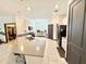 Modern kitchen featuring stainless steel appliances, a large island with seating, and open layout at 34004 Sky Blossom Cir, Leesburg, FL 34788