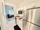 Modern kitchenette with stainless steel appliances and white cabinetry at 34004 Sky Blossom Cir, Leesburg, FL 34788