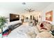 Spacious living room with tile floors, neutral colors, and open to the kitchen and dining area at 34004 Sky Blossom Cir, Leesburg, FL 34788