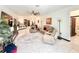 Open-concept living room with tile flooring, ceiling fan, and seamless flow to the kitchen and dining area at 34004 Sky Blossom Cir, Leesburg, FL 34788