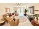 Inviting living room with comfortable seating, a ceiling fan, and sliding glass doors to the outside at 34004 Sky Blossom Cir, Leesburg, FL 34788