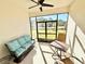 Screened-in patio showcases a cozy seating area, perfect for enjoying the outdoors at 34004 Sky Blossom Cir, Leesburg, FL 34788