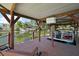Covered boat dock with seating and picturesque lake views at 34407 Island Dr, Leesburg, FL 34788