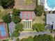 Overhead view of tennis courts, pickleball courts, and lawn bowling area with surrounding greenery and parking at 3723 Belle Rose Dr, Leesburg, FL 34748