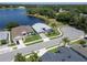 Aerial view of a well-maintained home nestled by a serene lake in a residential neighborhood at 3723 Belle Rose Dr, Leesburg, FL 34748