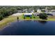 Lakefront home features a covered patio and beautiful landscaping at 3723 Belle Rose Dr, Leesburg, FL 34748