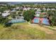 Aerial view of community pickleball and tennis courts offering a place for recreation and exercise at 3723 Belle Rose Dr, Leesburg, FL 34748