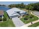 Spacious home with scenic lake view, lush landscaping, and a patterned brick driveway at 3723 Belle Rose Dr, Leesburg, FL 34748