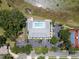 Aerial view of the community pool featuring a large pool deck with ample parking, surrounding the serene waters at 3723 Belle Rose Dr, Leesburg, FL 34748