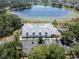 Aerial view of the clubhouse and community pool, surrounded by parking, near a pond, offering a luxurious retreat at 3723 Belle Rose Dr, Leesburg, FL 34748