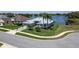 Picturesque waterfront property boasting beautiful landscaping and tropical palm trees at 3723 Belle Rose Dr, Leesburg, FL 34748