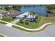 Lakefront home featuring meticulously landscaped yard and palm trees for tropical feel at 3723 Belle Rose Dr, Leesburg, FL 34748