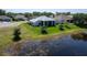 Charming home overlooking a lake with manicured backyard, mature landscaping and view at 3723 Belle Rose Dr, Leesburg, FL 34748