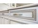 Close up of the bathroom's drawers with a decorative rope trim and crystal accented hardware at 3723 Belle Rose Dr, Leesburg, FL 34748