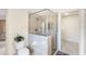 Bathroom featuring a glass-enclosed shower with tiled walls and a neutral color scheme at 3723 Belle Rose Dr, Leesburg, FL 34748