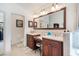 This bright bathroom has a vanity, makeup counter and a toilet with a decorative tiled floor at 3723 Belle Rose Dr, Leesburg, FL 34748