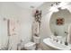 Half bathroom featuring a decorative shelf above the toilet with a decorative mirror at 3723 Belle Rose Dr, Leesburg, FL 34748
