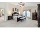 Spacious main bedroom with neutral colors, ceiling fan, and furnishings at 3723 Belle Rose Dr, Leesburg, FL 34748