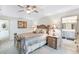 This cozy bedroom has a decorative bed and side tables with an ensuite bathroom at 3723 Belle Rose Dr, Leesburg, FL 34748