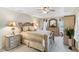 This is a lovely bedroom with a decorative bed, side tables, and dresser with plenty of natural light at 3723 Belle Rose Dr, Leesburg, FL 34748