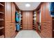 This custom closet features wood cabinets and shelving to maximize storage space for clothing and shoes at 3723 Belle Rose Dr, Leesburg, FL 34748