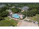 Aerial view of community amenities including pool, shuffleboard, clubhouse, and manicured lawns at 3723 Belle Rose Dr, Leesburg, FL 34748