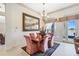 Bright dining room with lake view, chandelier lighting, ornate mirror, and seating for six at 3723 Belle Rose Dr, Leesburg, FL 34748