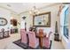 Formal dining room featuring a large mirror, chandelier, and elegant furnishings at 3723 Belle Rose Dr, Leesburg, FL 34748