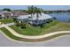 Charming home with a well-manicured lawn, mature landscaping, and serene lake views at 3723 Belle Rose Dr, Leesburg, FL 34748