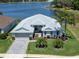 Beautiful lakefront home with lush lawn, mature landscaping, and charming paver driveway at 3723 Belle Rose Dr, Leesburg, FL 34748