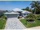 Charming single-story home featuring a spacious driveway and meticulously landscaped front yard at 3723 Belle Rose Dr, Leesburg, FL 34748