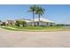 Well-maintained home with a bright exterior, surrounded by a green lawn and scenic lake view at 3723 Belle Rose Dr, Leesburg, FL 34748