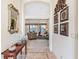 Inviting foyer featuring tile details, decorative accents, and a glimpse of the living area and water views at 3723 Belle Rose Dr, Leesburg, FL 34748