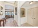 Welcoming foyer with tile accents, arched doorways, and view of the living room with a lake view at 3723 Belle Rose Dr, Leesburg, FL 34748