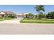 Inviting home with lush lawn, palm trees, and a brick driveway that enhances curb appeal at 3723 Belle Rose Dr, Leesburg, FL 34748