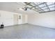 Spacious two-car garage with epoxy flooring and white walls ready for storage and parking at 3723 Belle Rose Dr, Leesburg, FL 34748
