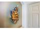 Artistic water feature attached to the wall in the hallway with gold lighting at 3723 Belle Rose Dr, Leesburg, FL 34748
