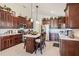 Spacious kitchen with granite countertops, a center island with seating, and stainless steel appliances at 3723 Belle Rose Dr, Leesburg, FL 34748