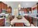 Spacious kitchen with granite counters, a center island, and stainless steel appliances at 3723 Belle Rose Dr, Leesburg, FL 34748