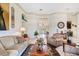 Open living area with comfortable seating, decorative details, and access to other home areas at 3723 Belle Rose Dr, Leesburg, FL 34748