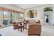 Comfortable living room with a cozy seating area, decorative accents, and picturesque views at 3723 Belle Rose Dr, Leesburg, FL 34748