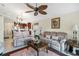 Comfortable living room with a ceiling fan leads to the kitchen, offering an open and inviting living space at 3723 Belle Rose Dr, Leesburg, FL 34748