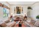 Relaxing living room featuring plush seating, decorative accents, and abundant natural light at 3723 Belle Rose Dr, Leesburg, FL 34748